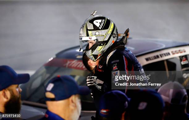 William Byron, driver of the Liberty University Chevrolet, celebrates with his driving coach Max Papis after winning the championship during the...