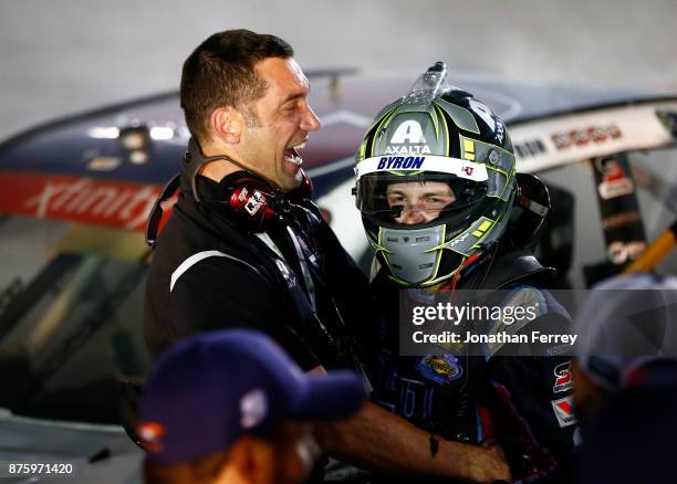 William Byron, driver of the Liberty University Chevrolet, celebrates with his driving coach Max Papis after winning the championship during the...