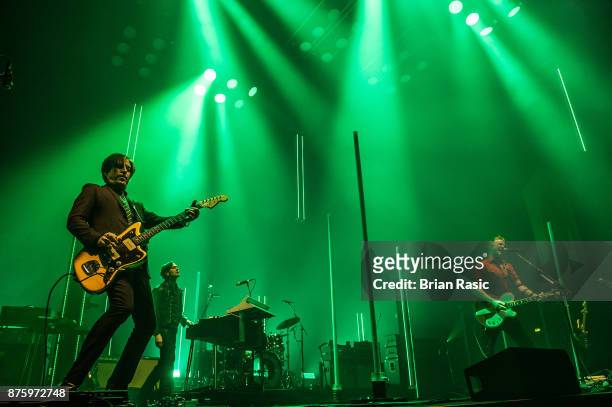 Troy Van Leeuwen , Dean Fertita and Josh Homme of Queens of the Stone Age perform at Wembley Arena on November 18, 2017 in London, England.