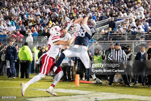 Mike Gesicki of the Penn State Nittany Lions makes a leaping touchdown reception above the hands of Chris Weber of the Nebraska Cornhuskers during...