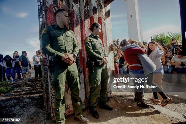 Cristal Brayan Ramirez Cervantes hugs Lucia Cervantes, while daughters Brenda Karely and Ashley de la Torres Ramirez look on atthe U.S. Mexico border...
