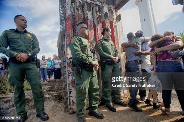 Family members embrace their loved ones during a reunification visit through a gate along the U.S. Mexico border November 18, 2017 in San Ysidro,...