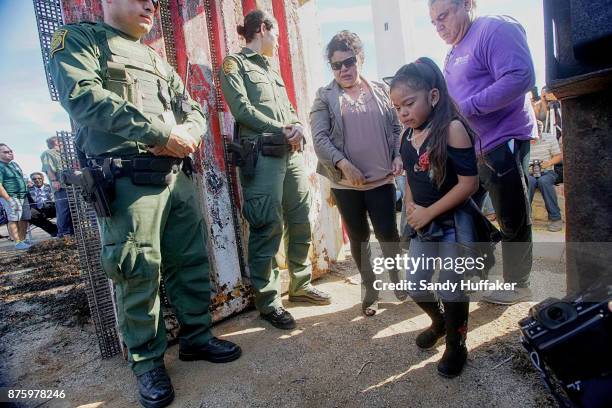 Jennifer Placensia Mariscal walks away after seeing family members on the Miexico sidethrough an open gate on Saturday, November 18, 2017. The event,...
