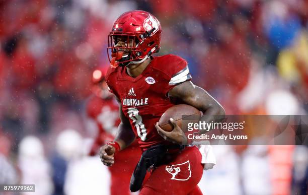 Lamar Jackson of the Louisville Cardinals runs for a touchdown against the Syracuse Orange during the game at Papa John's Cardinal Stadium on...