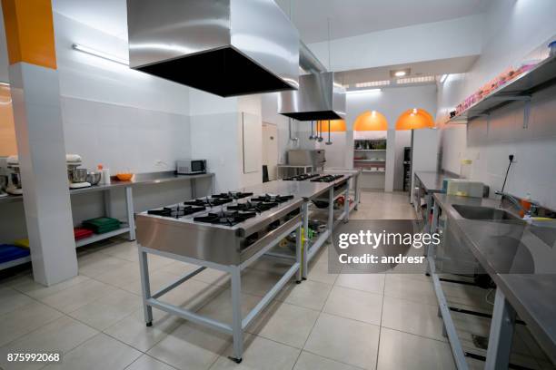 empty kitchen of a cooking academy - restaurant kitchen fridge stock pictures, royalty-free photos & images
