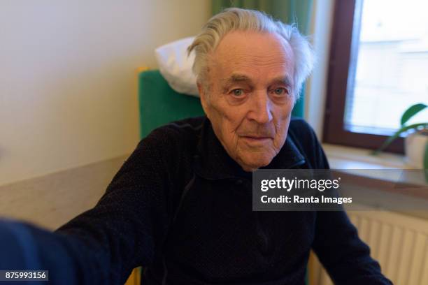 senior man relaxing by the window at nursing home in turku, finland - turku finland stock pictures, royalty-free photos & images