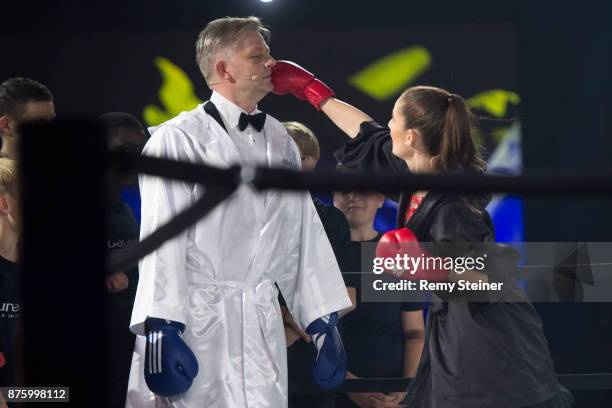 Cloe Salzgeber mimics to punch her father Rainer Maria Salzgeber during the 11th Laureus Charity Night at Hangar Duebendorf on November 18, 2017 near...