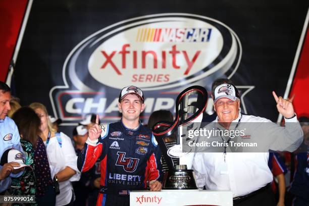 William Byron, driver of the Liberty University Chevrolet, and Rick Hendrick celebrate with the trophy in Victory Lane after placing third and...