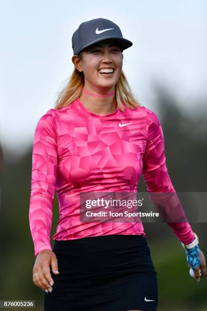 Happy Michelle Wie of the United States walks off the seventeenth hole after her successful birdie during the third round of the LPGA CME Group...