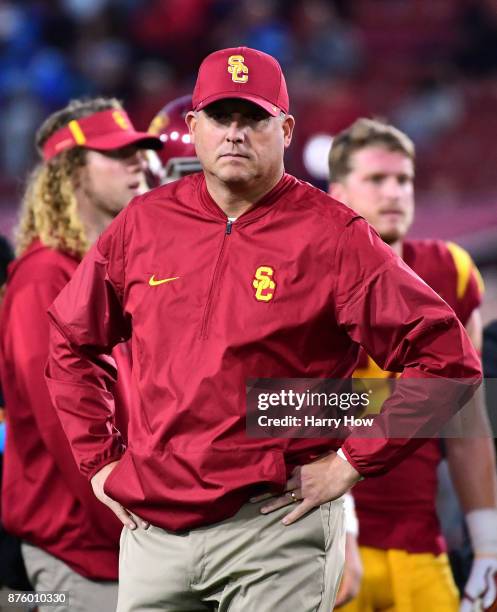 Head coach Clay Helton of the USC Trojans watches warm ups before the game against the UCLA Bruins at Los Angeles Memorial Coliseum on November 18,...