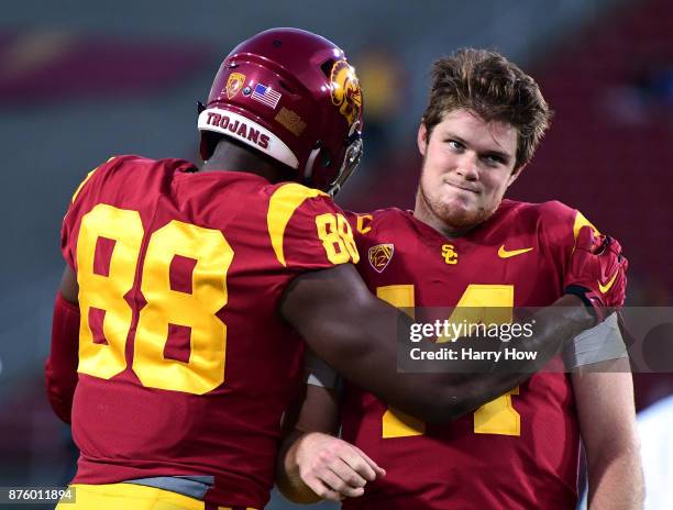 Sam Darnold of the USC Trojans jokes with Daniel Imatorbhebhe of the USC Trojans before the game against the UCLA Bruins at Los Angeles Memorial...