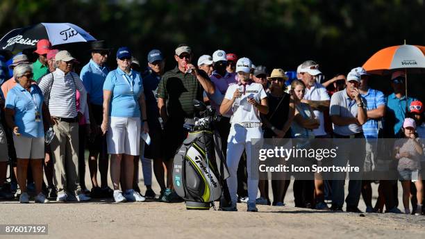 Spectators look on as Sung Hyun Park of South Korea prepares for her third shot on the seventeenth hole during the third round of the LPGA CME Group...