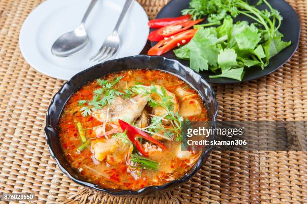 spicy thai cuisine with red curry and herb - curry soup stock-fotos und bilder