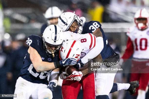 Lamont Wade and Troy Apke of the Penn State Nittany Lions tackle Stanley Morgan Jr. #8 of the Nebraska Cornhuskers, Apke was ejected for targeting on...