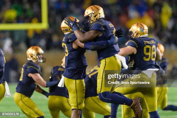 Notre Dame Fighting Irish defensive lineman Khalid Kareem and Notre Dame Fighting Irish defensive lineman Daelin Hayes celebrate a defensive play in...