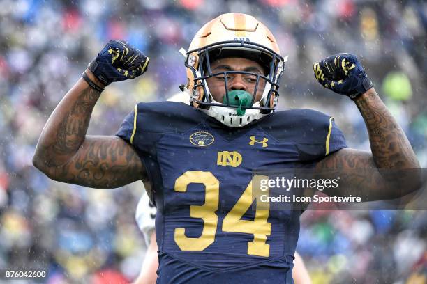 Notre Dame Fighting Irish running back Tony Jones Jr. Flexes to celebrate a play during the college football game between the Notre Dame Fighting...