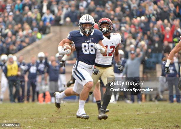 Yale Bulldogs wide receiver JP Shohfi runs the ball down the field while pursued by Harvard Crimson defensive back Isaiah Wingfield during the game...