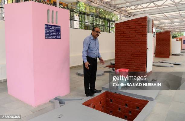 In this photograph taken on November 15 Sulabh International Museum of Toilets scientist R.C Jha displays a toilet that can incinerate waste in New...