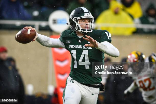 Michigan State Spartans quarterback Brian Lewerke rolls out to pass during a Big Ten conference college football game between Michigan State and...