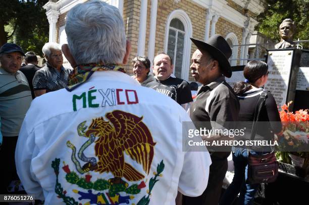 People visit the tomb of Mexican singer and actor Pedro Infante during the 100th anniversary of his birth, at the Panteon Jardin in Mexico City on...
