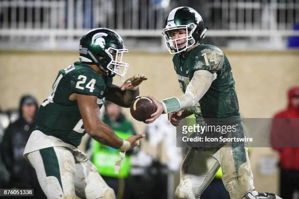 Michigan State Spartans quarterback Brian Lewerke hands off to running back Gerald Holmes during a Big Ten conference college football game between...