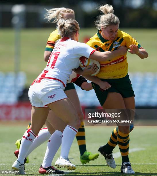 Ruan Sims of Australia is tackled during the 2017 Women's Rugby League World Cup match between Australia and England at Southern Cross Group Stadium...