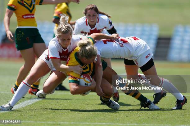 Ruan Sims of Australia is tackled during the 2017 Women's Rugby League World Cup match between Australia and England at Southern Cross Group Stadium...