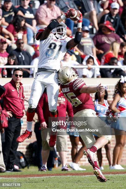 Wide Receiver Trey Gross of the Delaware State Hornets makes a catch over Defensive Back John Moschella, III of the Florida State Seminoles during...