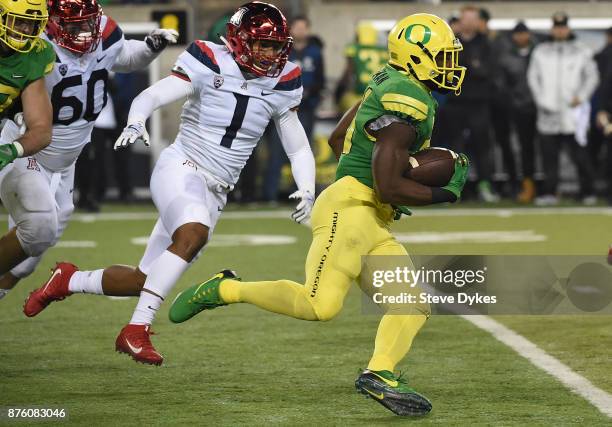 Running back Royce Freeman of the Oregon Ducks runs with the ball as linebacker Tony Fields II of the Arizona Wildcats closes in during the second...