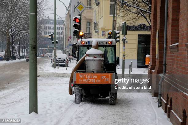 Winterdeinst beräumt einen Gehweg in Berlin-Prenzlauer Berg