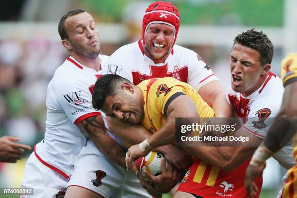 Rhyse Martin of Papua New Guinea is tackled by Luke Gale Chris Hill and Sam Burgess of England during the 2017 Rugby League World Cup Quarter Final...