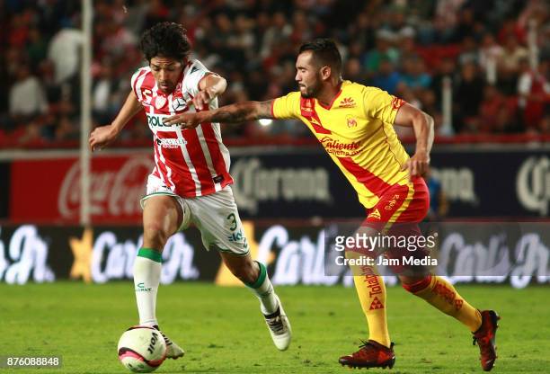 Matias Fernandez of Necaxa and Mario Osuna of Morelia fight for the ball during the 17th round match between Morelia and Necaxa as part of the Torneo...