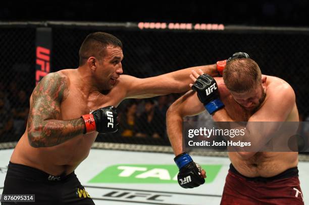 Fabricio Werdum of Brazil punches Marcin Tybura of Poland in their heavyweight bout during the UFC Fight Night event inside the Qudos Bank Arena on...