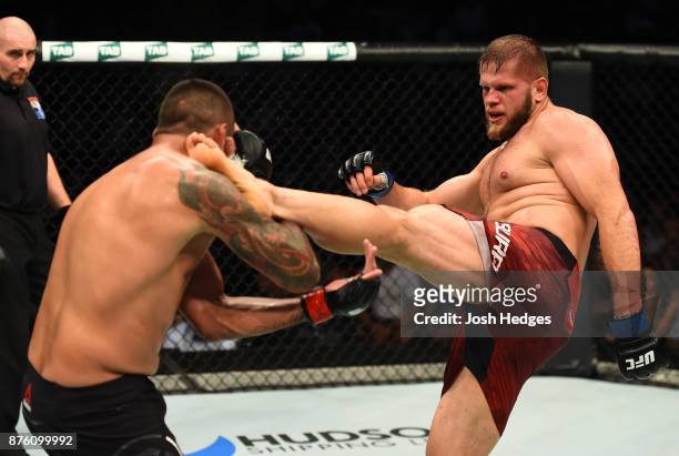 Marcin Tybura of Poland kicks Fabricio Werdum of Brazil in their heavyweight bout during the UFC Fight Night event inside the Qudos Bank Arena on...