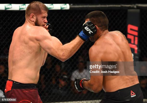 Marcin Tybura of Poland punches Fabricio Werdum of Brazil in their heavyweight bout during the UFC Fight Night event inside the Qudos Bank Arena on...