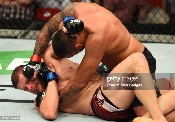 Fabricio Werdum of Brazil punches Marcin Tybura of Poland in their heavyweight bout during the UFC Fight Night event inside the Qudos Bank Arena on...