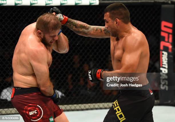 Fabricio Werdum of Brazil punches Marcin Tybura of Poland in their heavyweight bout during the UFC Fight Night event inside the Qudos Bank Arena on...