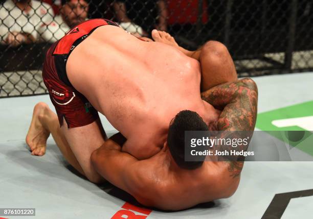 Fabricio Werdum of Brazil attempts to submit Marcin Tybura of Poland in their heavyweight bout during the UFC Fight Night event inside the Qudos Bank...