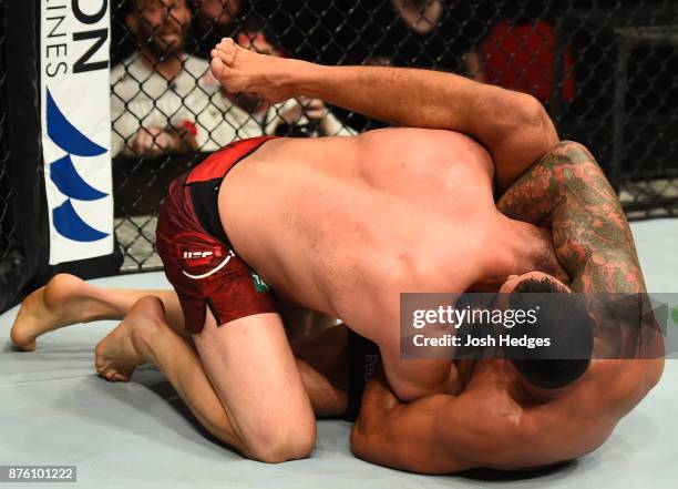 Fabricio Werdum of Brazil attempts to submit Marcin Tybura of Poland in their heavyweight bout during the UFC Fight Night event inside the Qudos Bank...