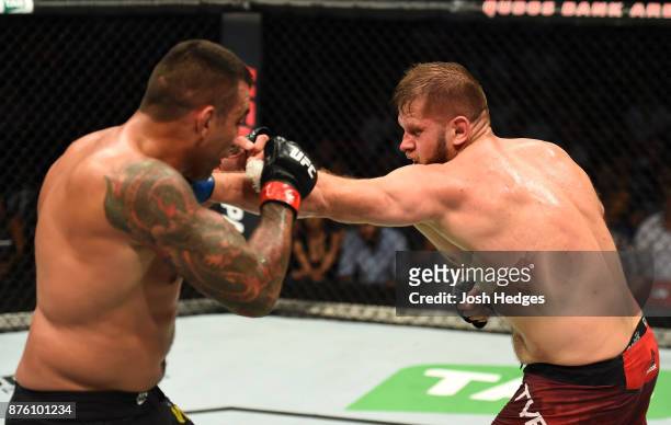 Marcin Tybura of Poland punches Fabricio Werdum of Brazil in their heavyweight bout during the UFC Fight Night event inside the Qudos Bank Arena on...