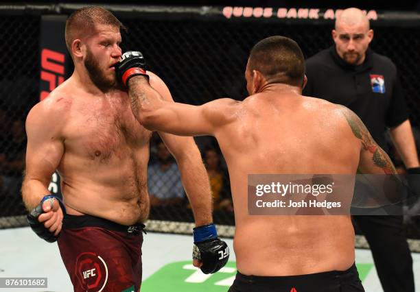 Fabricio Werdum of Brazil punches Marcin Tybura of Poland in their heavyweight bout during the UFC Fight Night event inside the Qudos Bank Arena on...
