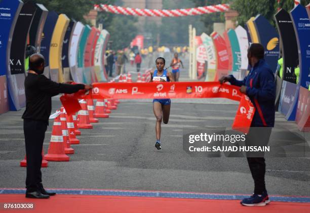 Almaz Ayana of Ethiopia runs towards the finish line to win the Airtel Delhi Half Marathon 2017 in New Delhi on November 19, 2017. In the women's...