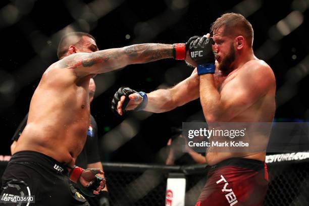 Fabricio Werdum of Brazil punches Marcin Tybura of Poland in their heavyweight bout during the UFC Fight Night at Qudos Bank Arena on November 19,...