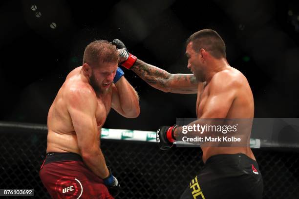 Fabricio Werdum of Brazil punches Marcin Tybura of Poland in their heavyweight bout during the UFC Fight Night at Qudos Bank Arena on November 19,...