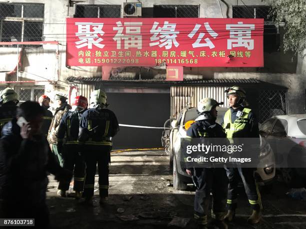 Firefighters work at the site after a house fire at Daxing District on November 19, 2017 in Beijing, China. Nineteen people were killed and eight...