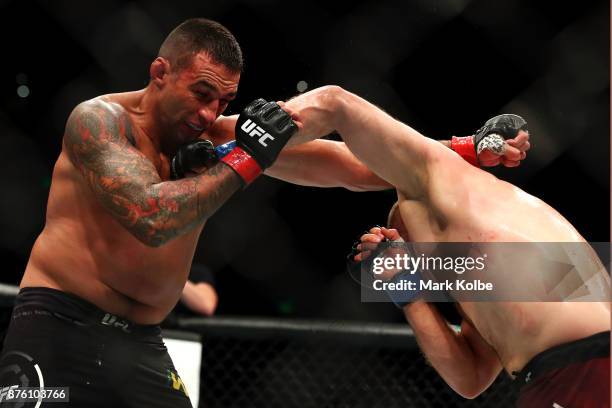 Marcin Tybura of Poland punches Fabricio Werdum of Brazil in their heavyweight bout during the UFC Fight Night at Qudos Bank Arena on November 19,...