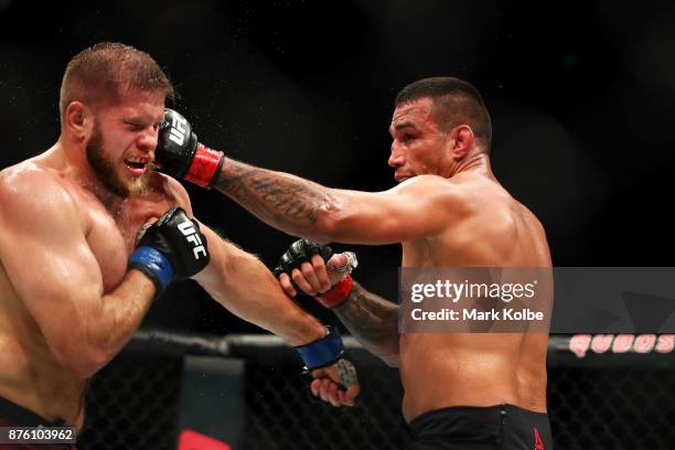 Fabricio Werdum of Brazil punches Marcin Tybura of Poland in their heavyweight bout during the UFC Fight Night at Qudos Bank Arena on November 19,...