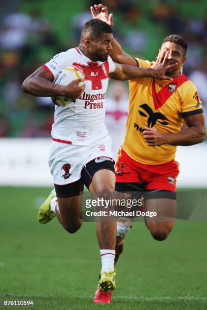 Kallum Watkins of England fends off and runs with the ball on his way to a try during the 2017 Rugby League World Cup Quarter Final match between...