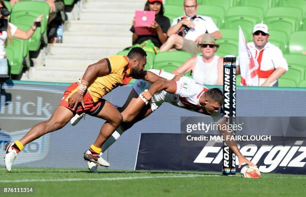 Englands Ryan Hall scores a try in front of Papua New Guineas Justin Olam during their Rugby League World Cup quarter-final match between England and...