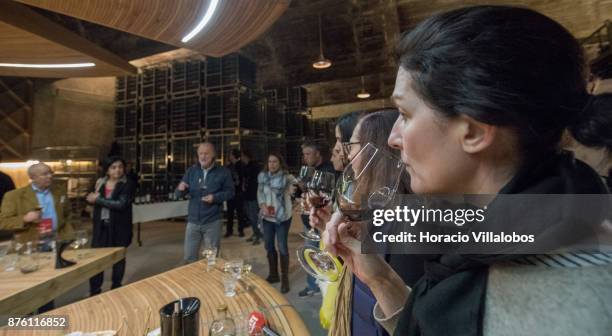 Visiting journalists taste wines in the cellars of Herdade do Esporao winery while receiving explanations from chief enologist David Baverstock...